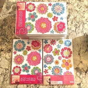15 packages of ADD•HERE’S Peel, Stick, Remove, Reposition Glitterpuff Flowers